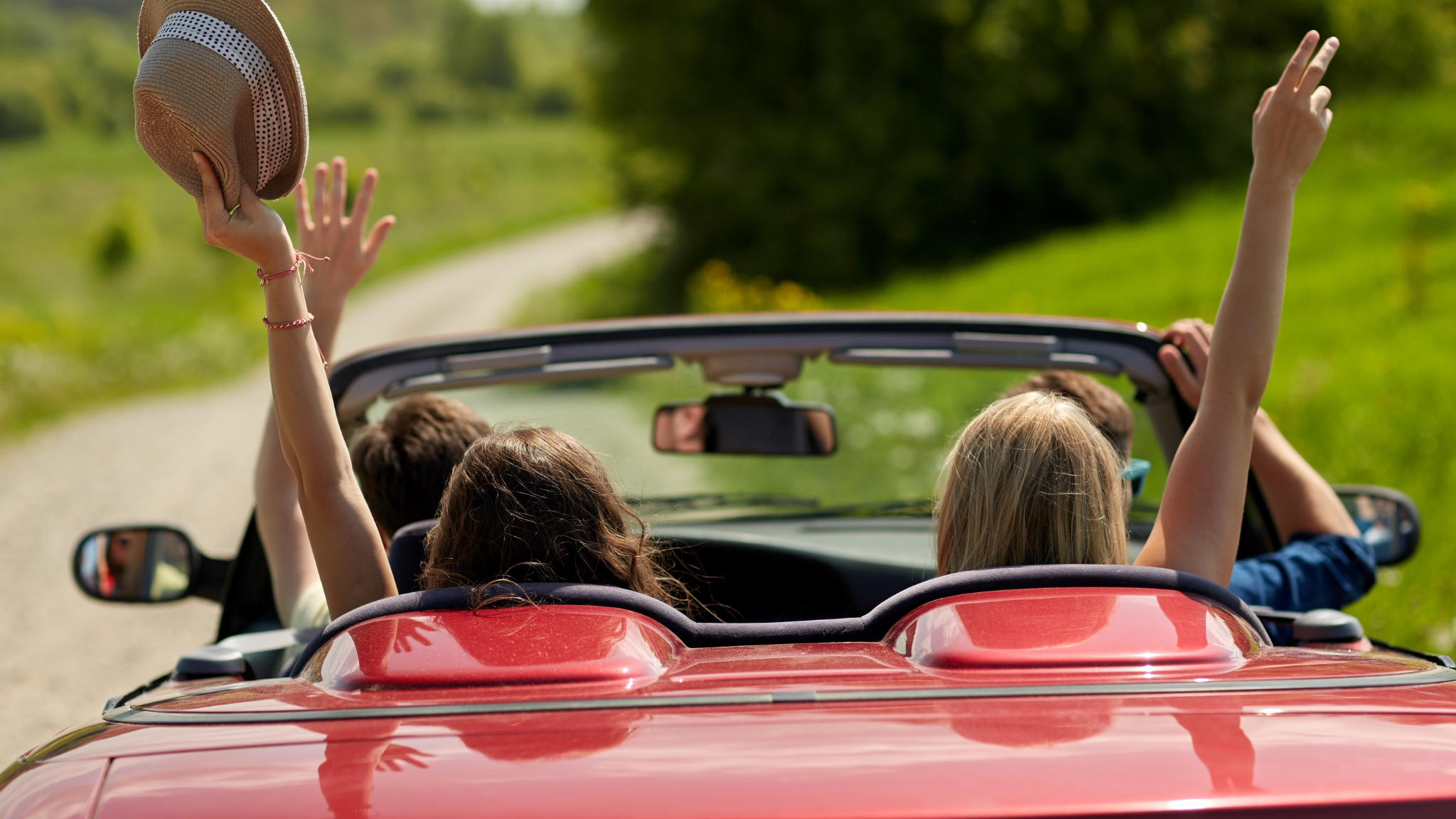 People-in-car-driving-away-with-hands-up
